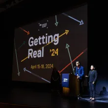 Abby Sun (Director of Artist Programs, IDA) and Dominic Asmall Willsdon (Executive Director, IDA) on the stage at the closing night of Getting Real ’24 conference.