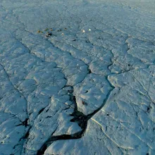 A Scientific Field Camp on The Greenland Ice Sheet, crisscrossed by crevasse traces and ice streams.