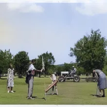 Caddies, one black one white, carrying golf bags for two ladies on the 6th green at Lions Municipal in Austin, Texas. We believe the caddie holding the flag is Alvin Propps, who at 9 years old desegregated the golf course in 1950, creating a civil rights landmark as the first golf course, and likely first public accommodation, in the former Confederate States to be integrated