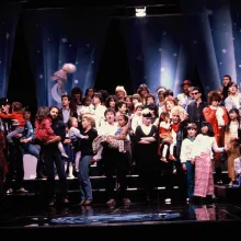 A large group of people celebrating on a stage