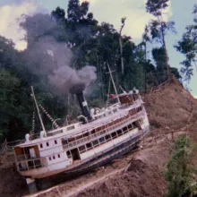 A large steamship being dragged up the side of a mountain.