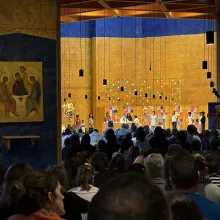 A crowd is gathered at a church for an evening prayer