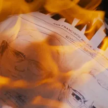 A wanted poster going up in flames.