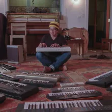 Musician Money Mark formerly of the Beasty Boys sits surrounded by various casios he uses to make his music.