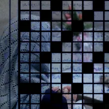 A grid with some blacked out boxes is overlaid on a film still of a woman with her back to the camera.