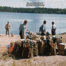 A group of people prepare for a canoe trip.