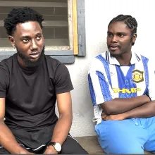 Two young men sitting on a veranda