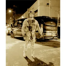 Sepia image of a sheriff in riot gear