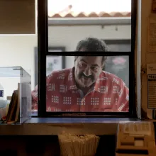 Ziad Karram peers through the front window of his old falafel shack, the Malibu Mutt.