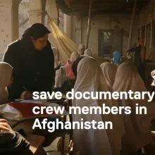 film still from 'Angels are Made of Light' of Afghan girls in school session in a courtyard.