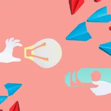 paper cutout of a hand holding a light bulb from the left, a hand holding money from the right; they are flanked by simple plane origamis at the diagonal corners.