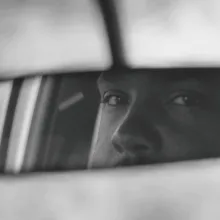 The eyes of a Black male driver reflected in a car's rearview mirror. From Geeta Gandbhir and Sam Pollard’s 'Lowndes County and the Road to Black Power.' Courtesy of Tribeca Festival. 