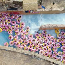 Drone shot of many pink plastic ring floats on a water ride. A scene from ‘Ascension’ (Directed by Jessica Kingdon, Produced by Kira Simon-Kennedy, Jessica Kingdon, Nathan Truesdell). Courtesy of Tribeca Film Festival