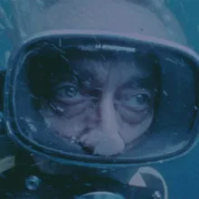 Film still of Jacques Costeau underwater in scuba diving gear. Courtesy of National Geographic