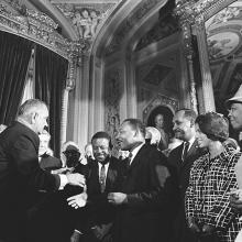 President Lyndon B. Johnson meets with Martin Luther King, Jr. at the signing of the Voting Rights Act of 1965.