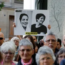 A protestor holds up a banner with Nasrin Sotoudeh’s photo. It says “Free Nasrin.” From 'Nasrin' (Director: Jeff Kaufman). Courtesy of David Magdael & Associates