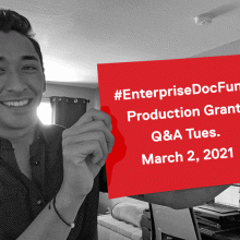 Grants Coordinator Kenny Brown, man in 20s with mixed Asian and European ancestry, holding up paper with text: "#EnterpriseDocFund Q&A Tues. March 2, 2021"