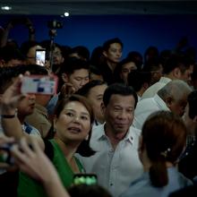 crowds surround Philippine President