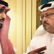 Two Saudi man in traditional robes are talking to each other