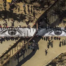 A birds eye view of a large mural of two eyes.