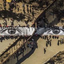 A birds eye view of a large mural of two eyes.