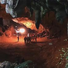 A group of people inside a dark cave.