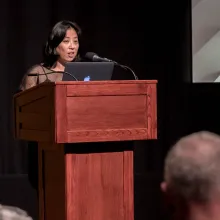Grace Lee speaking behind the podium.
