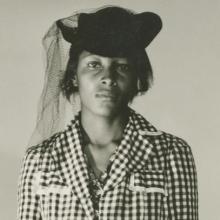 Recy Taylor wears a checkered blouse and a black hat with a veil