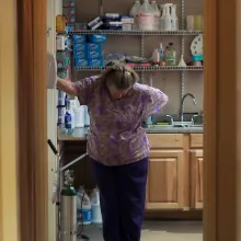 Kansas abortion doctor stands in office doorway looking down towards the ground