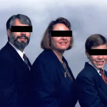 white couple with young son pose for family portrait with their eyes covered by black censor bars