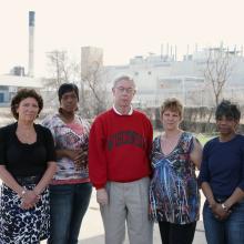 former factory employees posed outside of warehouse in Wisconsin