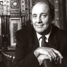 A headshot of Marshall Meyers sitting in a Synagogue 