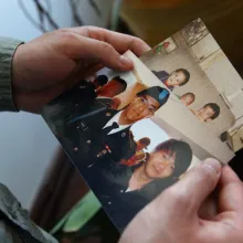 photo of hands holding image of a victim of hazing