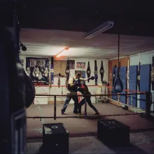 Mariah boxes with her male coach in an empty boxing gym