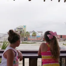 two young boys and two young girls stare away from camera looking onto a Mississippi street.