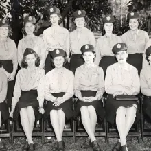 A large seated portrait of 18 WWII-era female military nurses