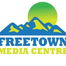 Logo: A green sun rises over a mountain range. Underneath the mountain is the text "Freetown Media Center"