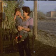 A young Jasmin Mara López held by her mother, Sandra, in the yard of their home in Baja California, Mexico.