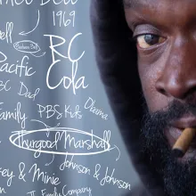 A Black unhoused man smokes a cigarette, handwritten thought maps surround his head.