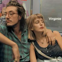 Two Caucasian couple is sitting in a metro subway.