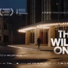 A man walks down a dimly lit street, white text in the foreground says 'The Wild One'