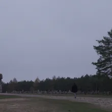 Treblinka Monument at a distance with a figure walking through the stones.
