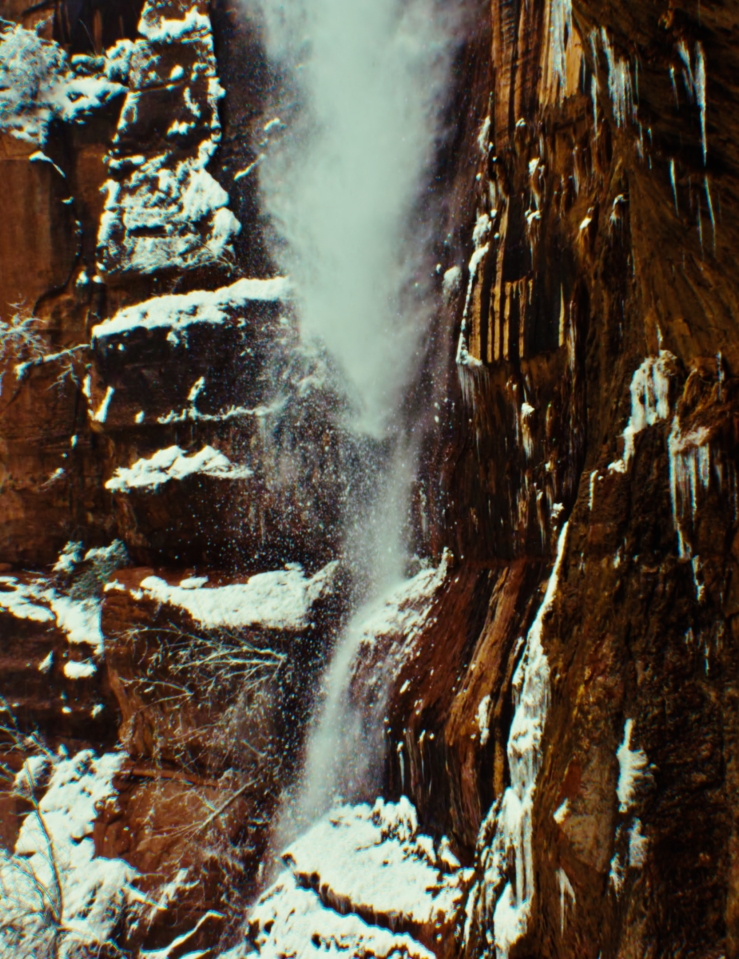 Snow tumbles over a cliff edge in Zion National Park.