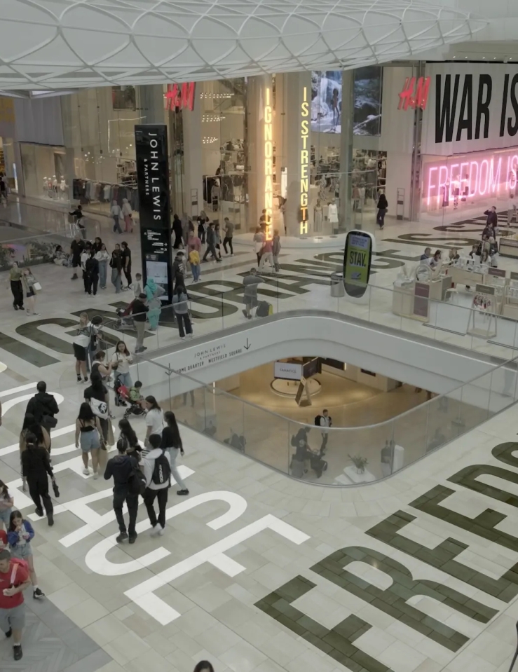 Overhead shot of a shopping center with logos and slogans.