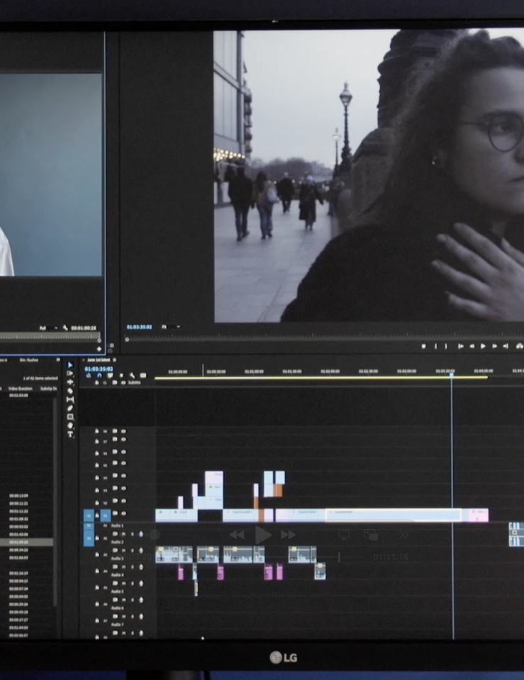 A monitor shows a film project being cut using editing software 